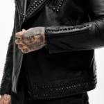 Biker wearing a mens studded motorcycle jacket with a rugged design