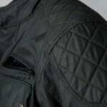 Stylish black waxed cotton motorcycle jacket with weatherproof finish and classic design