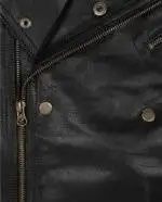 Close-up of the asymmetrical zipper on a men's black motorcycle leather jacket.