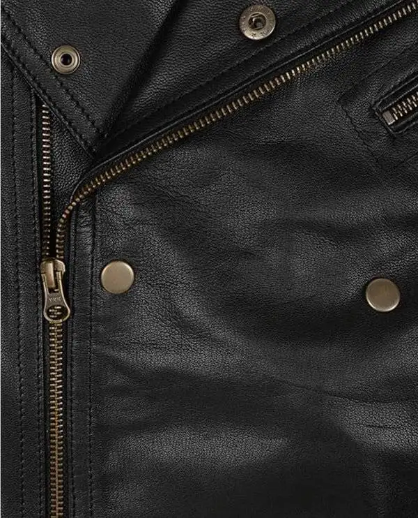 Close-up of the asymmetrical zipper on a men's black motorcycle leather jacket.