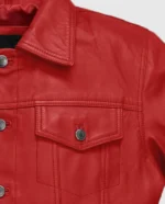 Close-up of a men's red leather trucker jacket showing the stitching, zippers, and hardware.