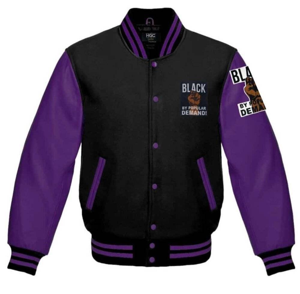 Close-up of a purple and black varsity jacket showing the stitching, pockets, and ribbed details.