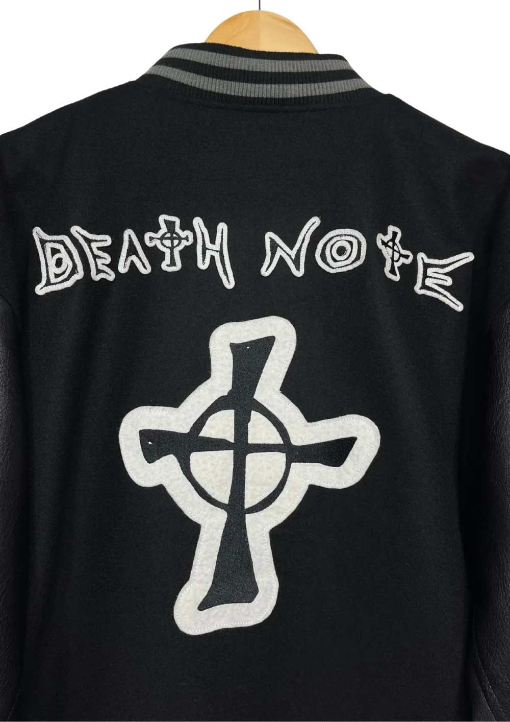 Close-up of the Death Note wool/leather black varsity jacket's back, showcasing the ribbed panel.