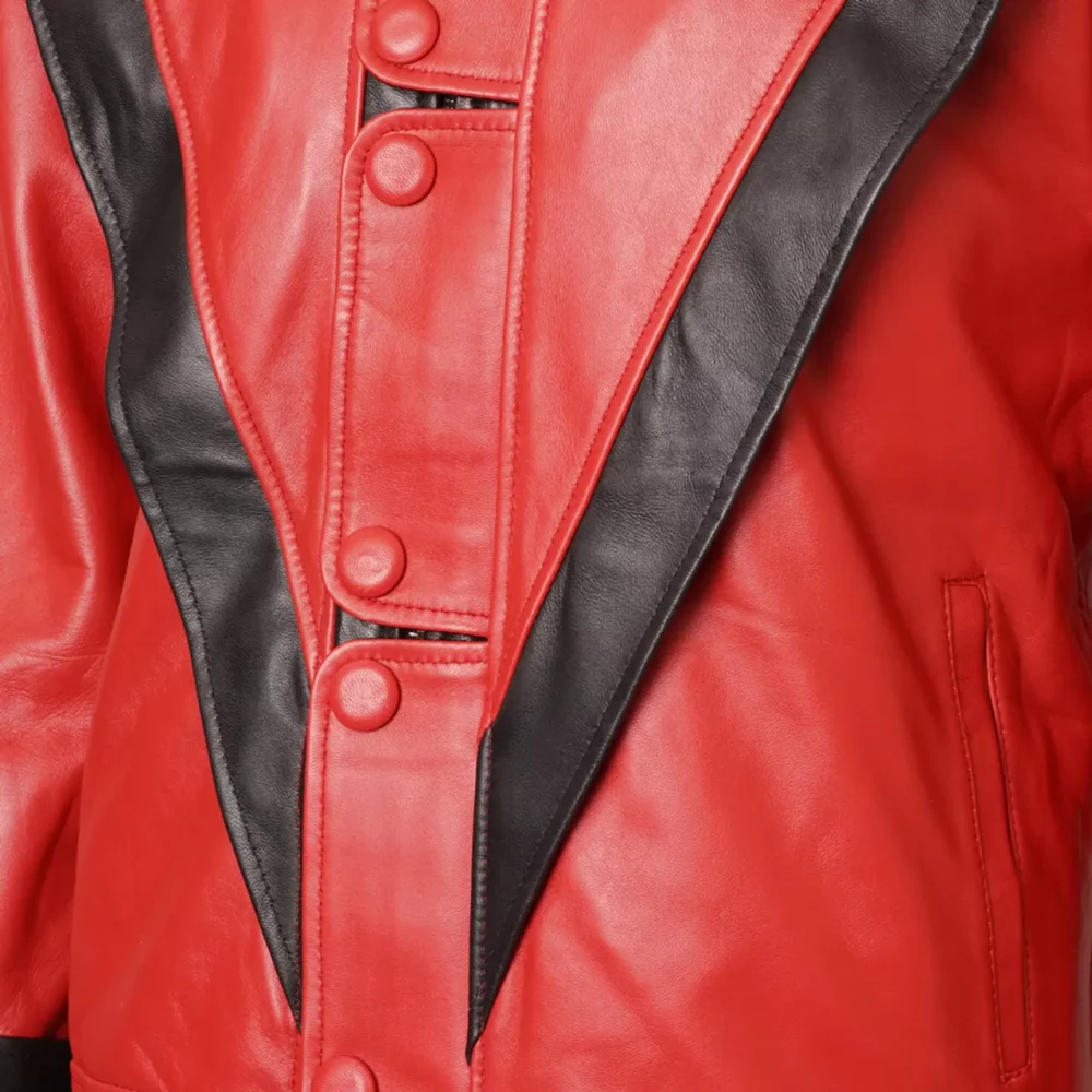 Close-up of the Michael Jackson Thriller red and black leather jacket, featuring the stitching, zipper, and ribbed cuffs.