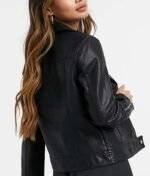 Back view of the Riverdale Toni Topaz black leather biker jacket, showcasing the full silhouette and detailing.