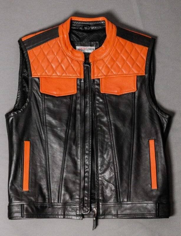 Black and orange diamond-stitched leather motorcycle vest with a snap closure and concealed pockets.