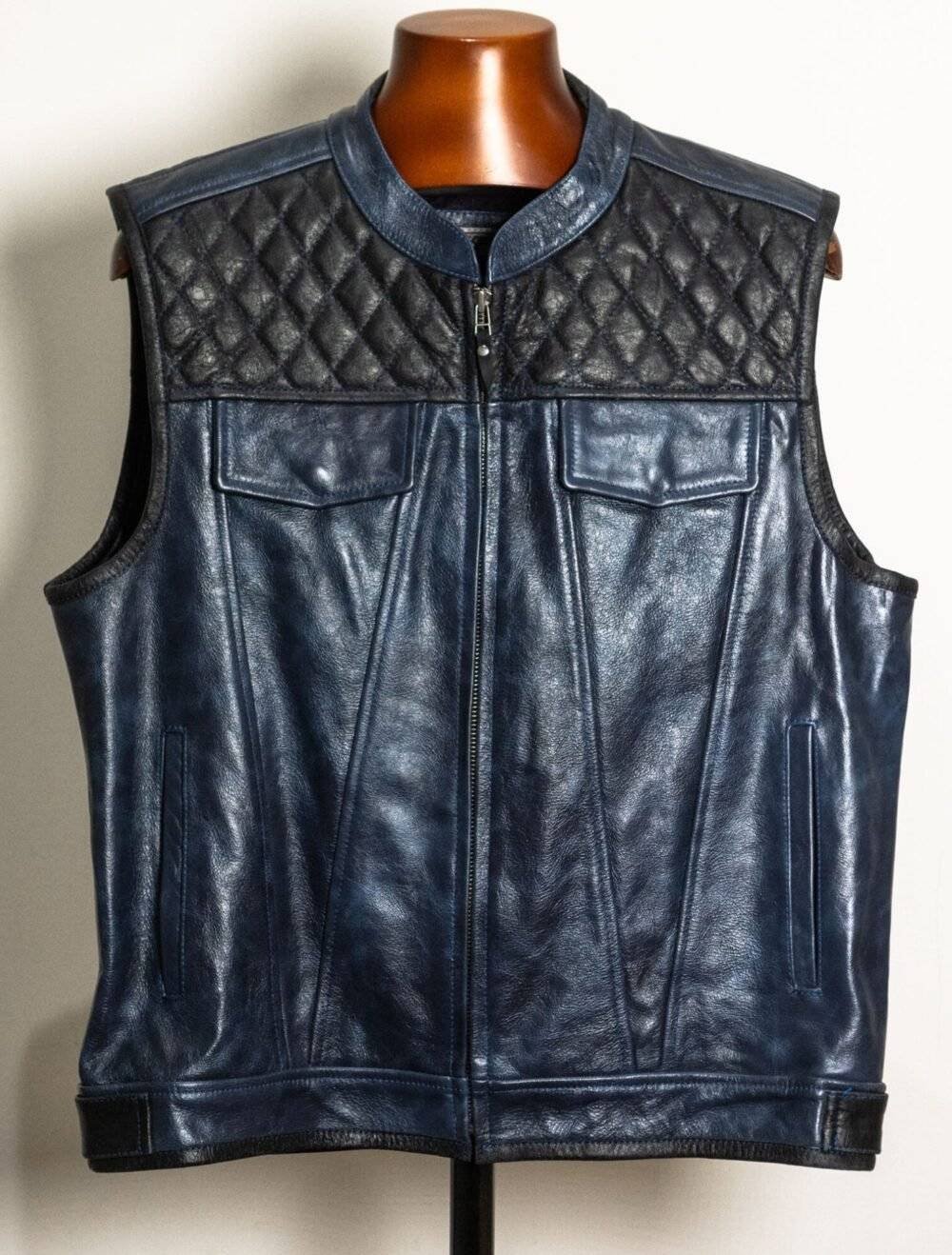 Handcrafted blue and black diamond-stitched leather motorcycle vest with multiple pockets and a zipper closure.