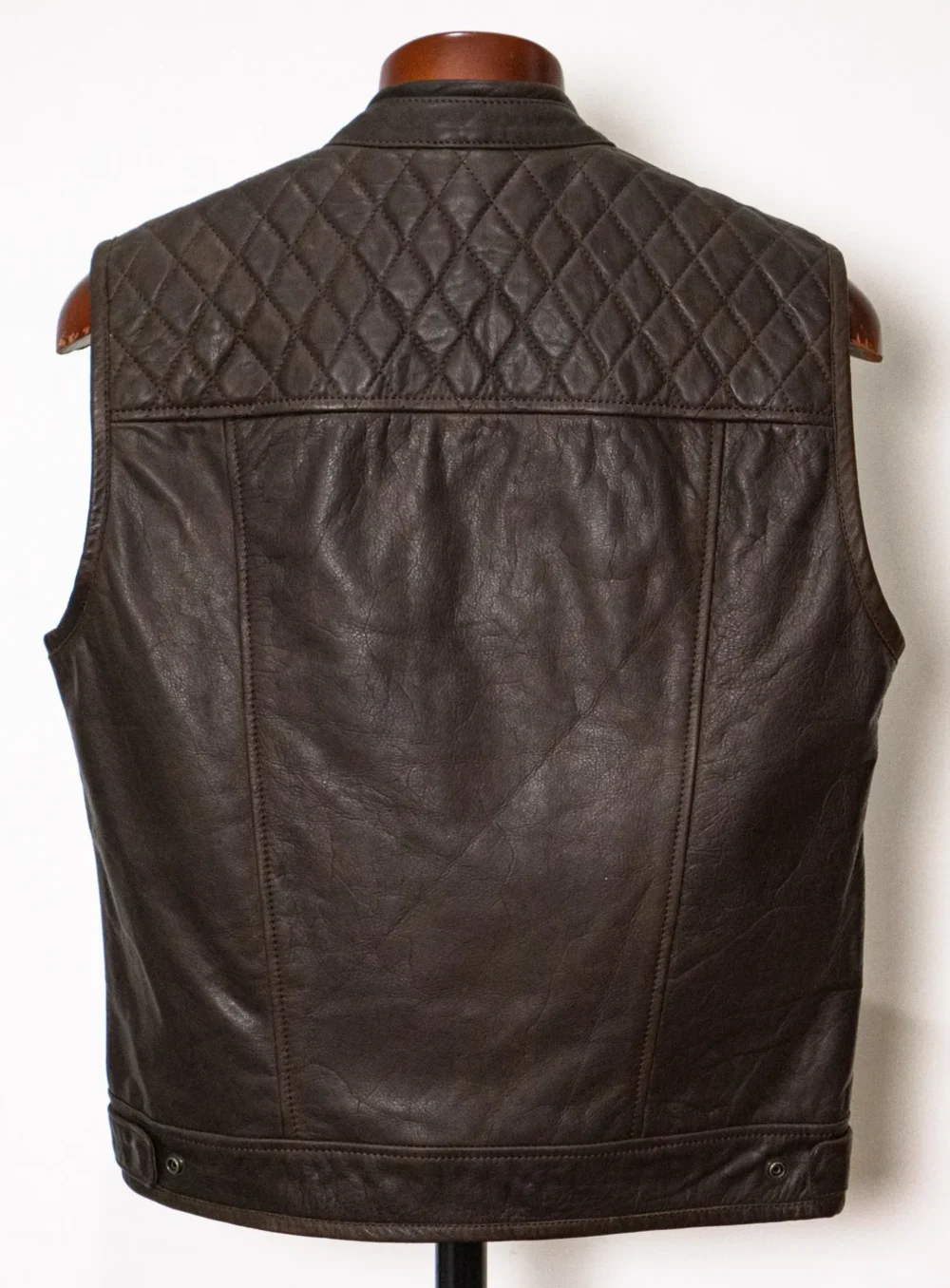 Back view of a brown diamond-stitched motorcycle vest with zipper closure and full interior leather facings.