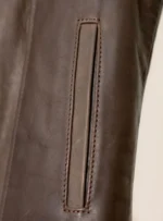 Close-up of a concealed pocket on a brown diamond-stitched motorcycle vest.