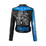 Back view of a women's black faux leather biker jacket with studded rivets and a graffiti pattern.