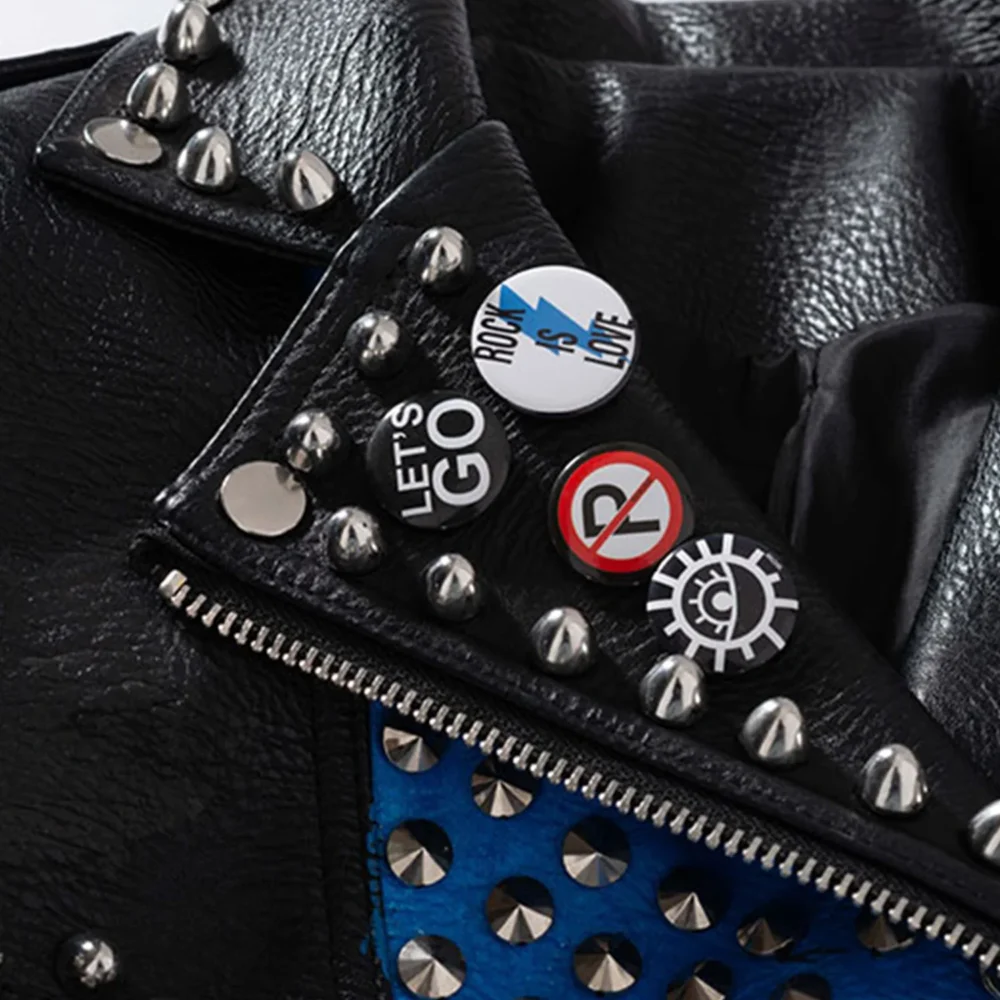 Close-up of the collar on a women's black faux leather biker jacket, showing the studded rivets and turn-down design.