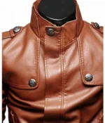 Close-up of a tan brown leather jacket with a stand-up collar and buttoned front.