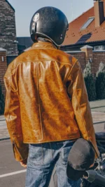 Back view of an orange brown leather racing jacket with shoulder, elbow, and back protection.