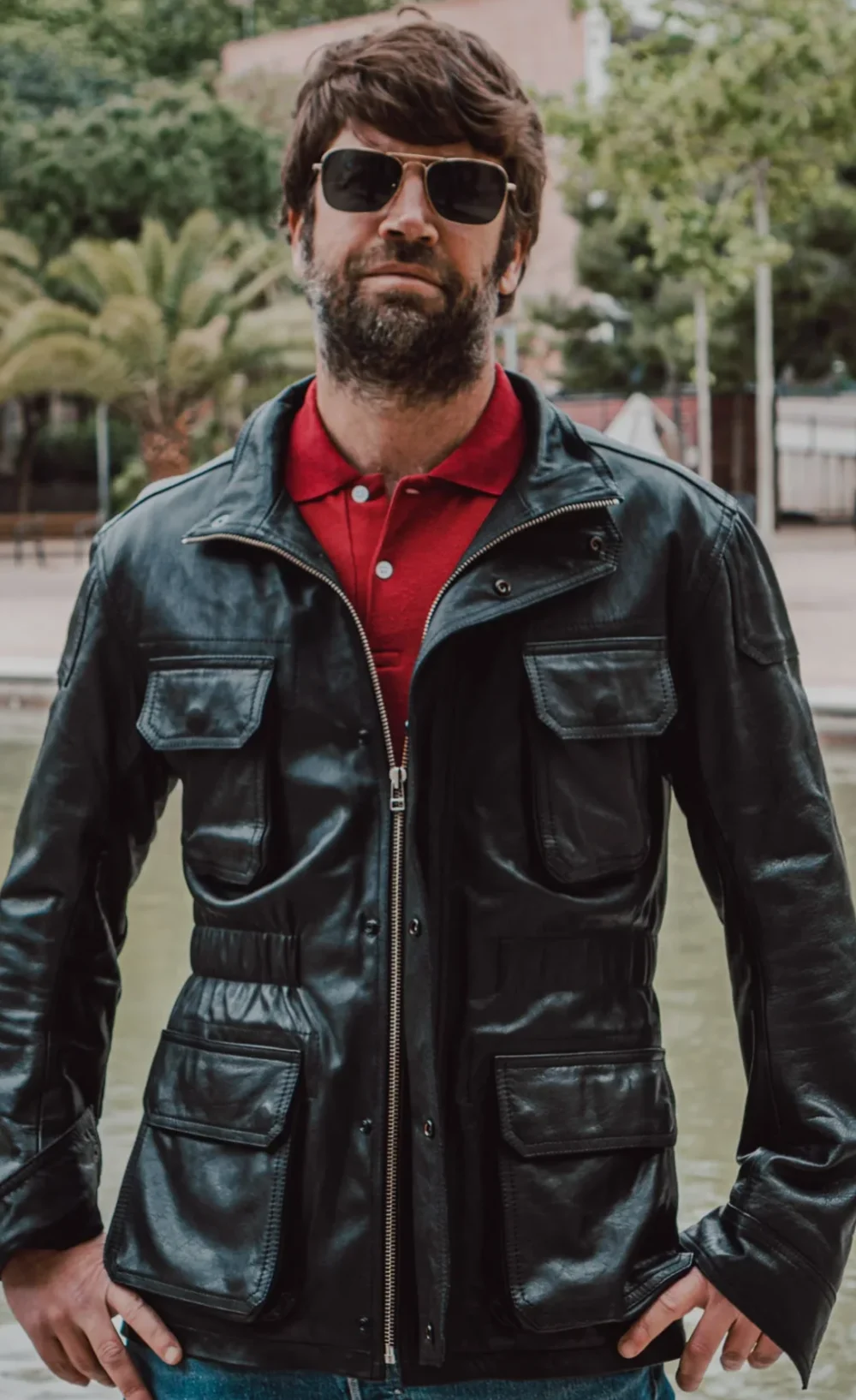 Black handcrafted leather jacket with a military safari design, featuring a YKK zipper and functional pockets.