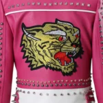 Close-up of the tiger embroidery on a pink faux leather jacket.