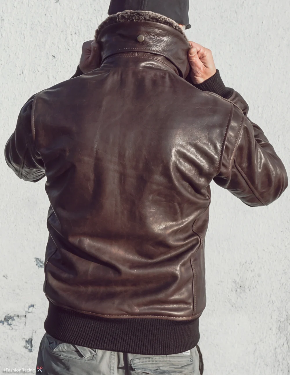 Back view of the men's brown vintage aviator leather jacket with side entry pockets and a tailored fit.