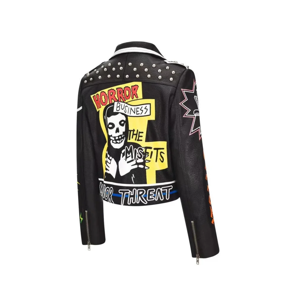 Tilted back view of a women's black punk rock leather jacket, showcasing the studded rivets and graffiti print.